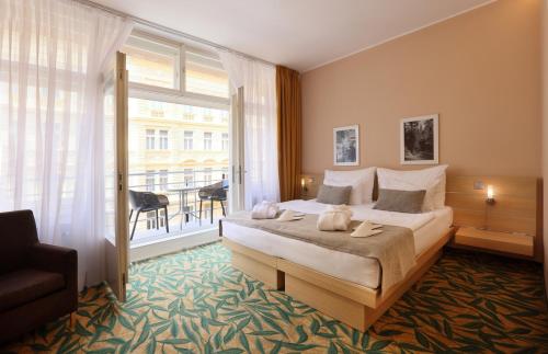 a hotel room with a bed and a large window at Amarilis in Prague