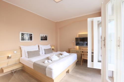 a bedroom with a large white bed and a television at Amarilis in Prague