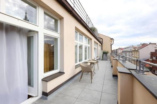 a balcony with chairs and windows on a building at Amarilis in Prague