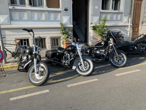 three motorcycles parked on the side of a street at Hotel Lukas Vegetarian & Vegan in Viareggio