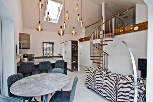 a kitchen and dining room with a table and chairs at Contemporary 2 bedroom eco home with a twist in Marton