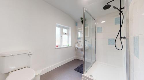 a bathroom with a shower and a toilet and a sink at Private Room in a Shared Accommodation in Norwood