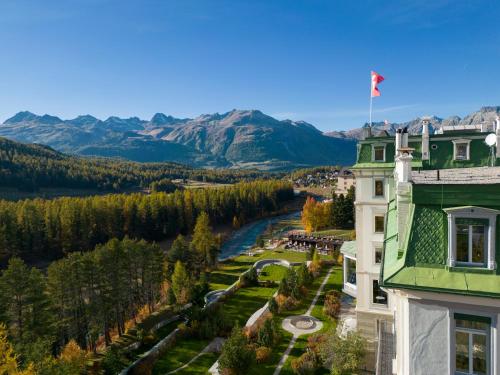 a building with a view of a river and mountains at Grand Hotel Kronenhof in Pontresina