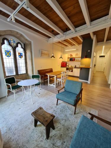 a large living room with a table and chairs at Pensión A Xanela in Pontevedra
