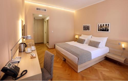 a hotel room with a bed and a desk at Amarilis in Prague