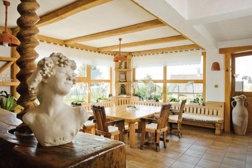 a bust of a woman sitting on a table in a dining room at Hiša vina Cuk in Lendava