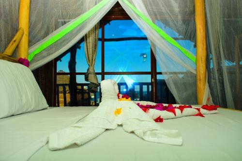 a bed with a star made out of a towel at Mwananchi Bungalows in Paje