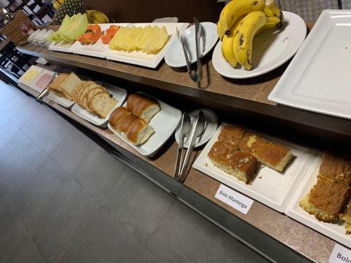 a display case with different types of bread and bananas at Pousada Choppão in Feliz