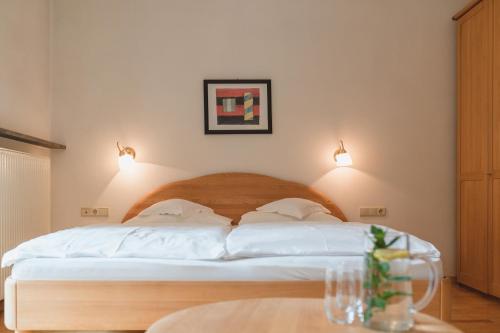 a bedroom with a bed with two pillows on it at Guesthouse St Nikolaus in Ultimo