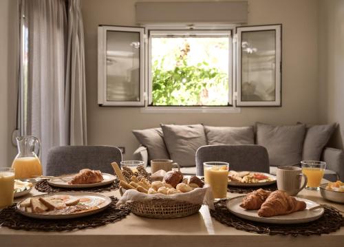 a table with plates of food on top of it at San Giorgios Maisonettes in Laganas