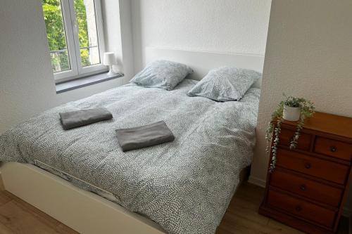 a bedroom with a bed with two pillows on it at Gramat appartement centre ville in Gramat