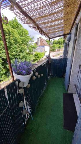 a patio with a planter on the side of a house at Gramat appartement centre ville in Gramat