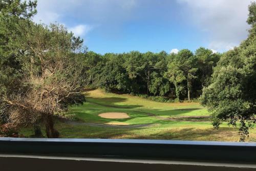 a view from a window of a golf course at Appart Cosy Green, Océan, Golf, Piscine, Wifi in Moliets-et-Maa