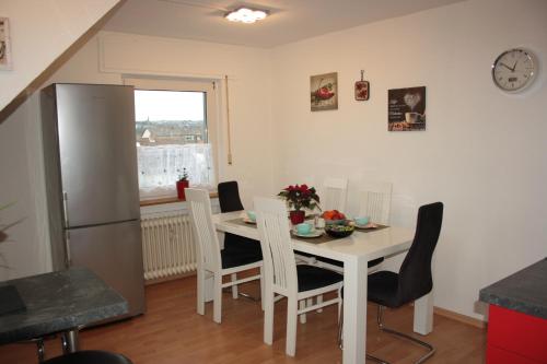 a kitchen and dining room with a white table and chairs at Diamanthaus 3 Koblenz in Koblenz