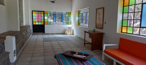 a room with stained glass windows and a couch at TADASANA CASA DE CAMPO in La Carrera