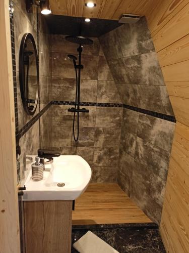 a bathroom with a sink and a mirror at Luxury Glamp in Bańska Niżna