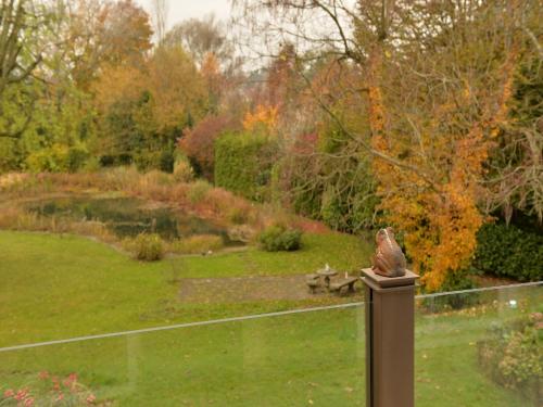 a bird statue sitting on a fence in a garden at Villa Rana in Lindau