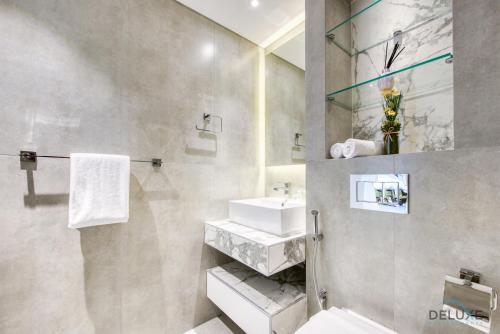 a bathroom with a sink and a toilet at Ideal 1BR at Marina Quay West Dubai Marina by Deluxe Holiday Homes in Dubai