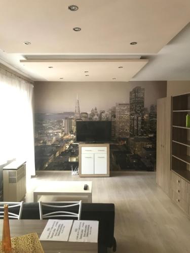 a living room with a wall mural of a city at Diszkrét szállás in Szekszárd