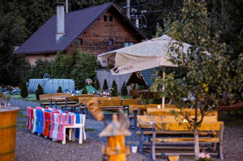a toy garden with tables and chairs and an umbrella at CASA HOBAN in Baia Mare