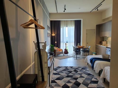 a hotel room with a bed and a dining room at The Perfect Getaway @ Tamarind Suites, Netflix 300Mbps in Cyberjaya
