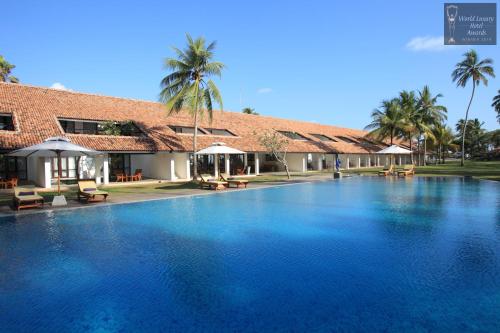 a large swimming pool in front of a building at Thaala Bentota in Bentota