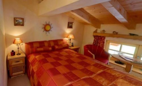 a bedroom with a bed and a desk and a window at Winklmoos Sonnenalm in Reit im Winkl