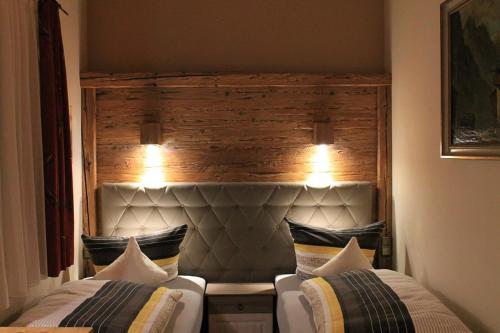 a bedroom with two beds and a head board at Winklmoos Sonnenalm in Reit im Winkl