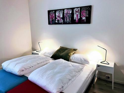 two beds in a room with two lamps on them at Apartment with two bedrooms and parking in Stavanger