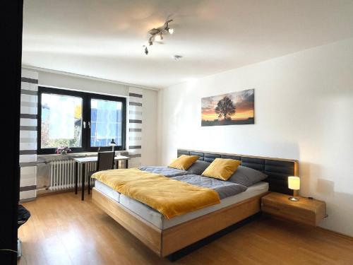 a bedroom with a bed and a desk and a window at Ferienwohnung Hoamatgfühl in Furth im Wald