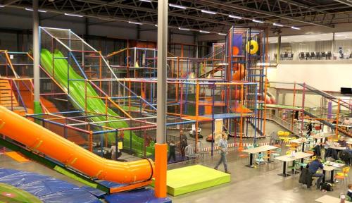 an indoor playground with a slide in a building at Vakantiewoning & Fietslogies V E L O, Tussen Hasselt en Maastricht in Bilzen