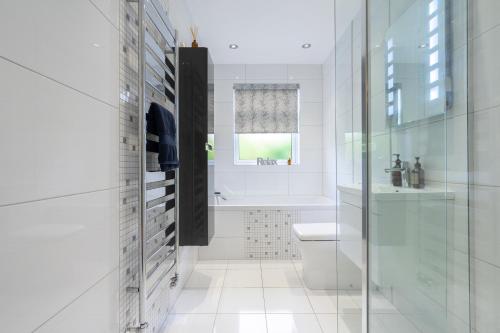 a white bathroom with a toilet and a sink at Craigey Beach Home in Edinburgh