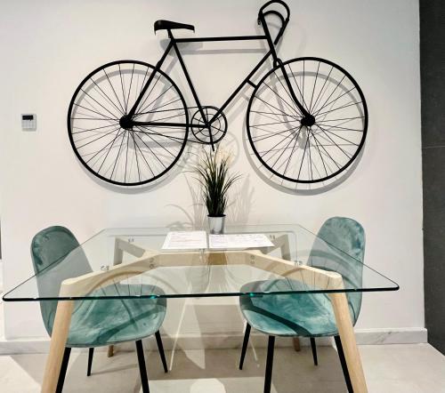 a bike hanging on a wall above a glass table at Sliema Studios in Sliema