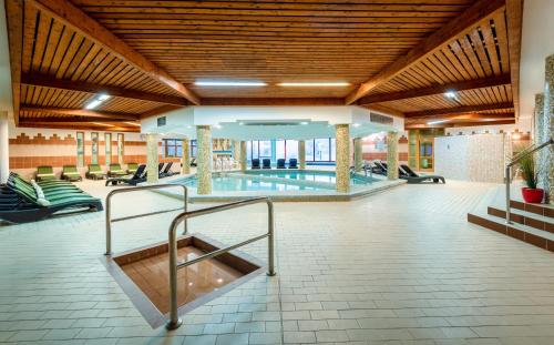 a swimming pool in a large building with a pool at Hunguest Hotel Pelion in Tapolca