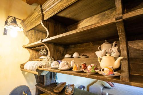a shelf with cups and dishes on it at Villa Romeo - Etna gateway in Piedimonte Etneo