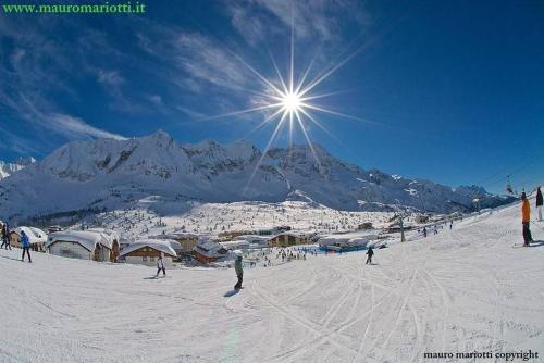 a group of people skiing on a snow covered mountain at Brici's House 69 in Passo del Tonale