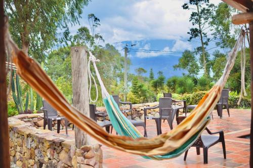 a couple of hammocks on a patio at Cabaña en la Mesa de los Santos in Pescadero