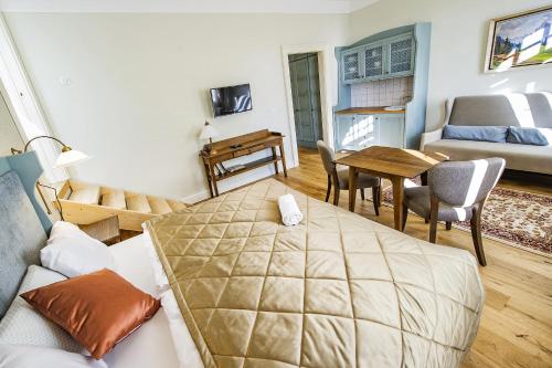 a bedroom with a bed and a living room at Vila Lavina in Smokovce