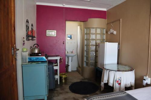 a kitchen with a refrigerator and a sink at Rocks & Roses Farm stay in Lochiel