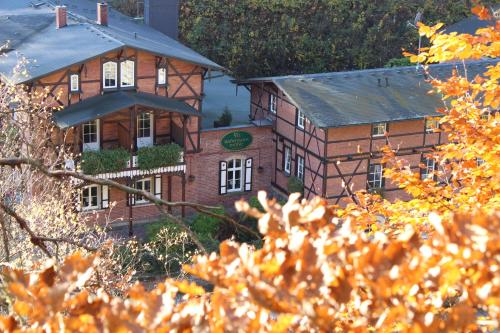 a large brick building in front of a building at Rabenauer Mühle "bed & breakfast" in Rabenau