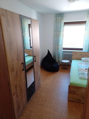 a room with a bed and a mirror at Fewo Frizzi in Richelbach