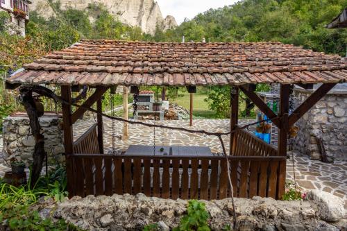 a wooden gazebo with a roof on top at Apartment R. Dermendzhiev in Melnik