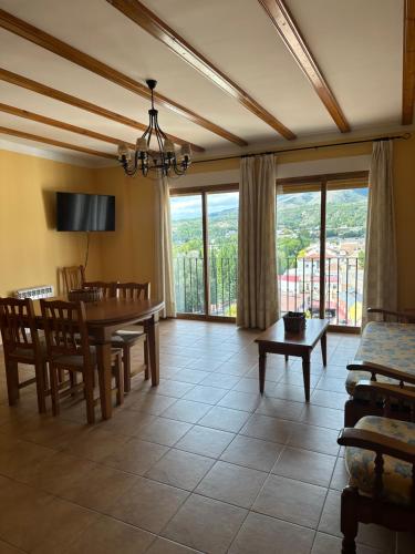 a living room with a table and a dining room at Apartamentos Cuesta de la Cruz in Caravaca de la Cruz