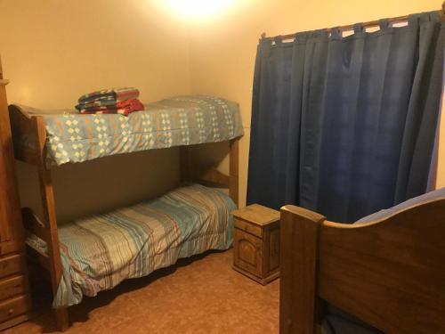 a bedroom with a bunk bed and a crib at Complejo olivos in Las Grutas