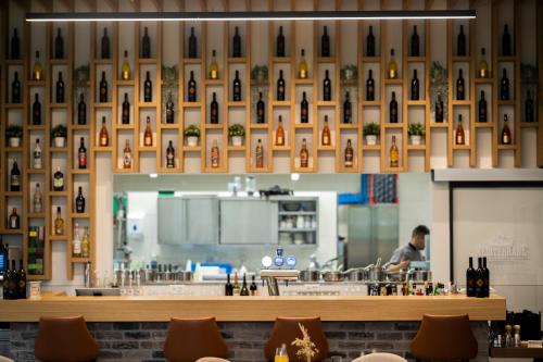a man standing behind a counter in a restaurant at City Hotel Glarnerland in Näfels