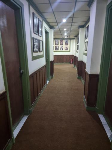 an empty hallway in a building with green and white walls at Carlton Downtown Cairo in Cairo