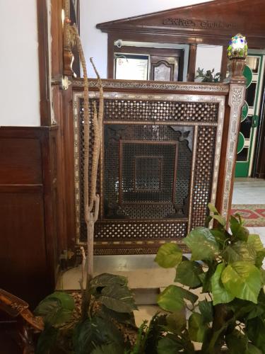 an old fireplace in a room with a plant at Carlton Downtown Cairo in Cairo