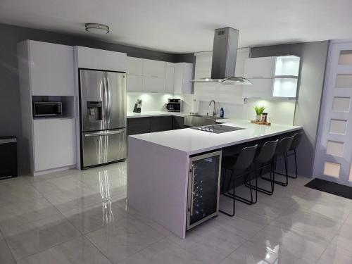 a kitchen with a white counter and stainless steel appliances at Luxury 3-bedrooms near airport in San Juan in San Juan