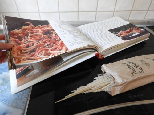 an open book on top of a table with spaghetti at JANs in Herdorf