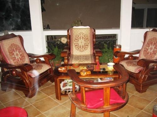 a living room with several chairs and a table and a table at Apartments Mond in Sutomore